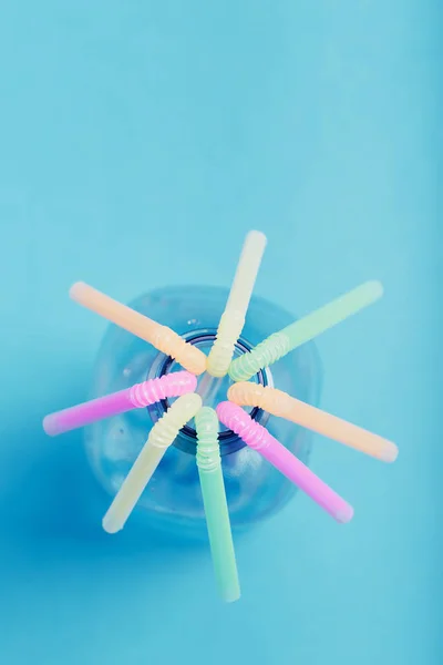 Plastic bottle with colorful straws