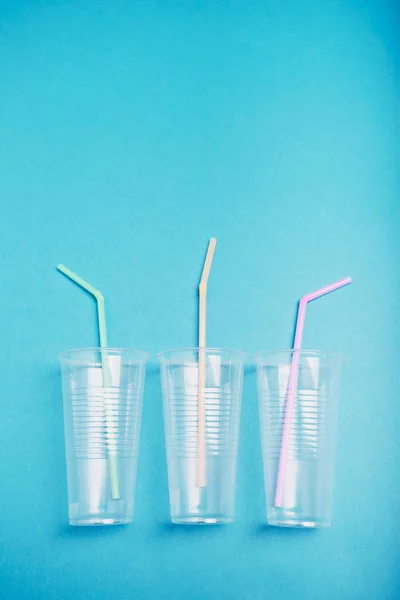 Empty plastic cups with colorful straws