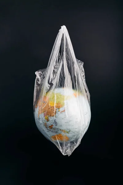 Globe in a plastic bag. Earth contaminated by plastic waste