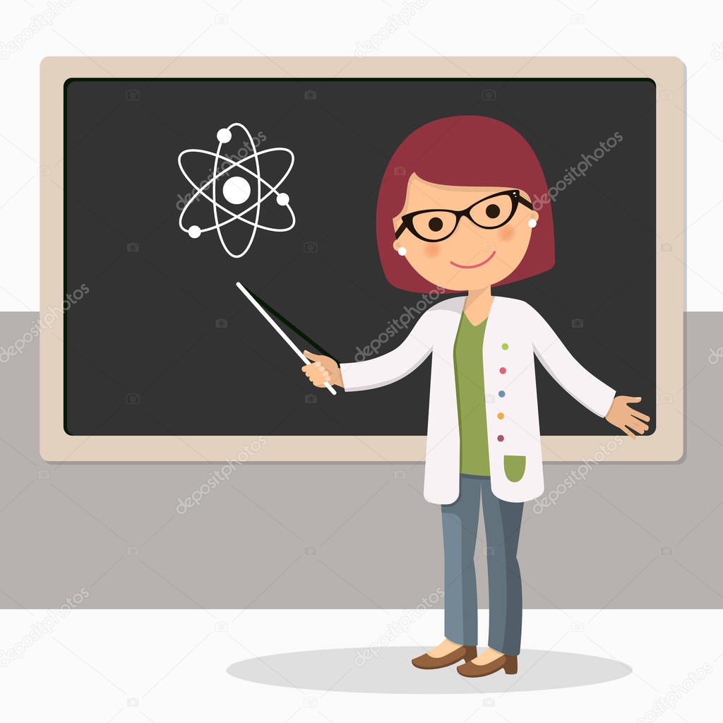 Young female teacher on science lesson at blackboard in classroom