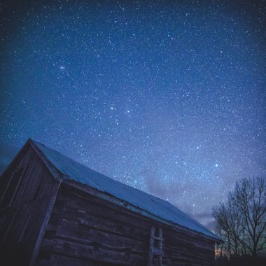 Rural Log Cabin barn at night with stars and milky way clipart