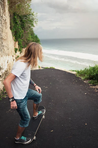 Patinador desce a estrada para a praia — Fotografia de Stock