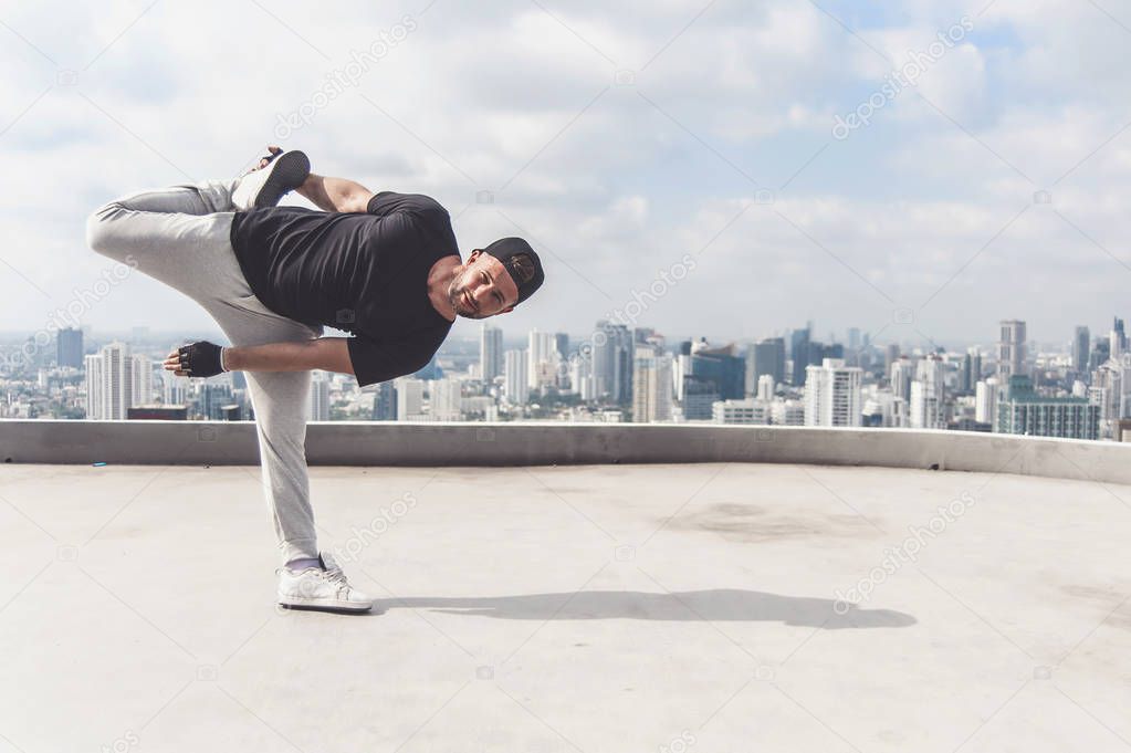 Bboy doing some stunts. Street artist breakdancing outdoors