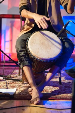Musician playing djembe drum clipart