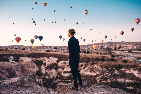 Fiatal ember nyaralni Törökországban Cappadocia nézi a léggömbök napkeltekor Kapadokya — Stock Fotó