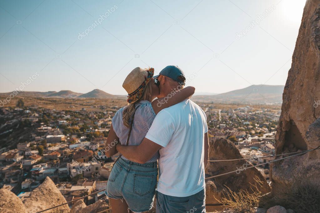Couple in love enjoyng amazing view from Uchisar Castle in Cappadocia.