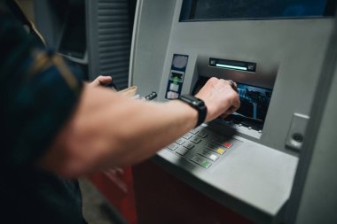 ATM kartı ve ATM kartı kullanarak erkek eli kapat.