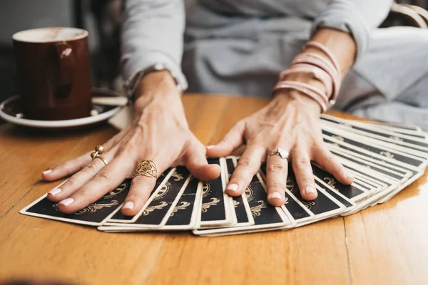 Vrouw leest Tarot kaarten op tafel in café — Stockfoto