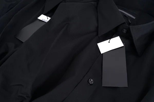 New black colour shirt and blank label — Stock Photo, Image