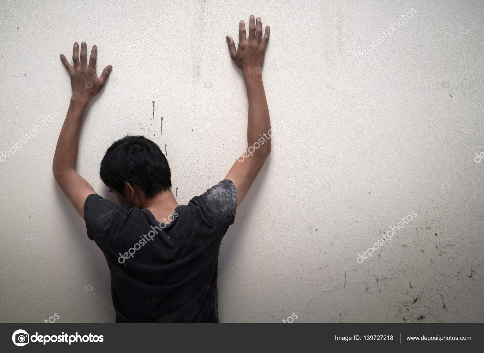 Man Show Hands Up Facing The Wall Stock Photo C Anankkml