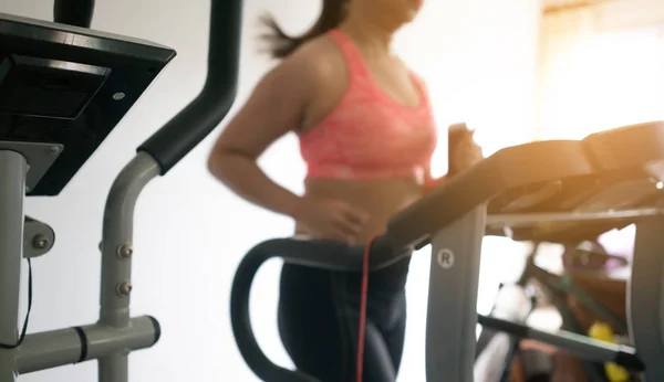 Woman in sportswear running on treadmill — Stock Photo, Image