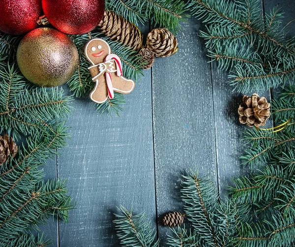 Gingerbread man with cane and Christmas balls — Stock Photo, Image