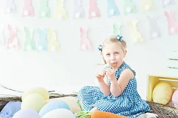 Cute funny girl with basket full of Easter eggs at home — Stock Photo, Image