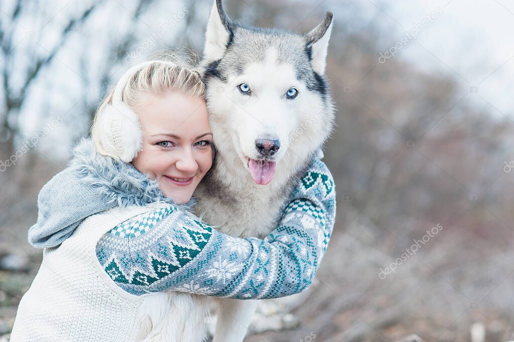 Young woman hugging her dog husky