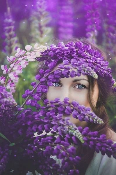 美しい女性が畑の夕日に紫色のラインブーケを持っています 自然とロマンスの概念は — ストック写真