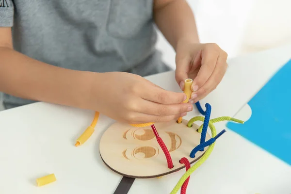 development of fine motor skills. child makes picture of different grains.