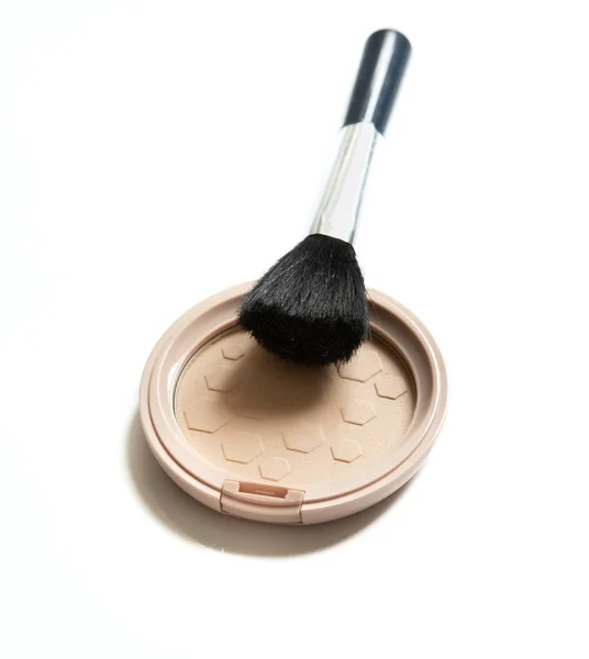 Face powder and brush isolated on white