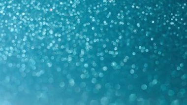 Mavi parıltılı dokular, noel arkaplanı soyut. Işıltılı, parlak arka plan bulanık duvar kağıdı. Parlak, parlak parçacıklar. Işık parıldayan hareket