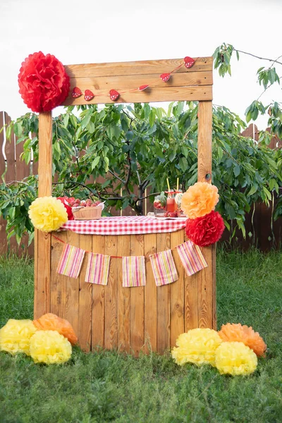 Lemonade Stand. strawberry lemonade with ice and mint as summer refreshing drink in jars. Cold soft drinks mocktail with fruit