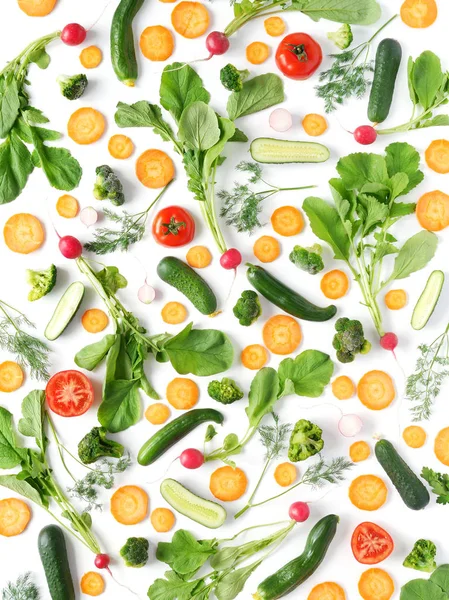 Fresh vegetables and greens on a white background. Pattern of vegetables. Radish, carrots, tomatoes, cucumbers, dill isolated on white background. Vegetable background wallpaper. Top view, flat lay