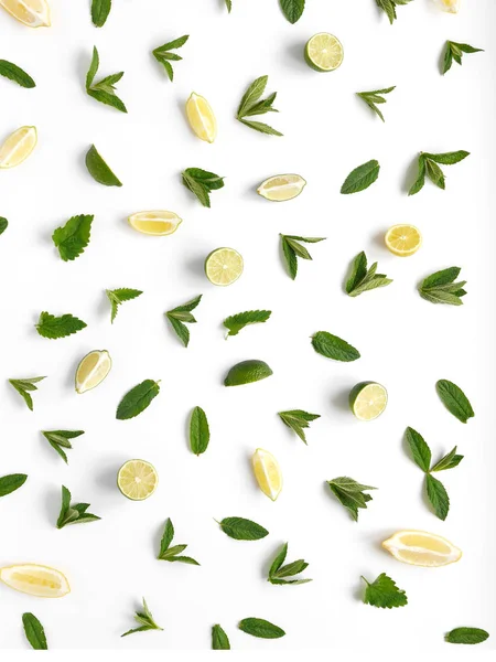 Pattern of citrus fruits. Slices of lemon, lime and mint on a white background. Top view, flat lay