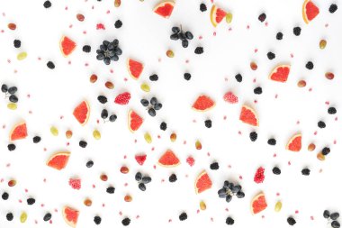 Greyfurt, böğürtlen, beyaz zemin üzerine nar, siyah ve Yeşil üzüm taneleri dilimleri