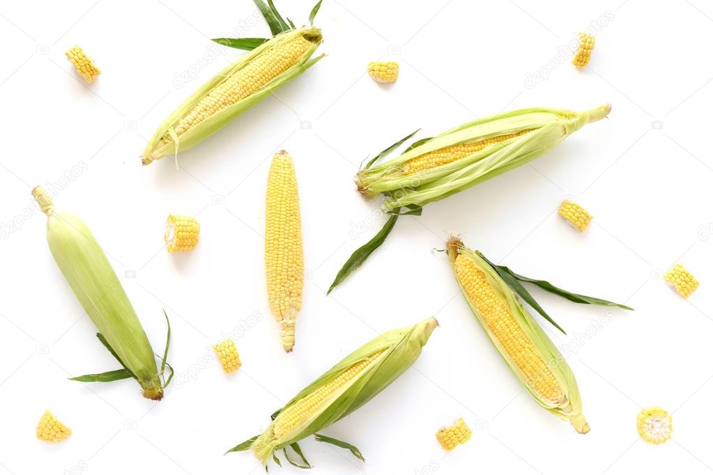 Close view of corncob and pieces against white background 