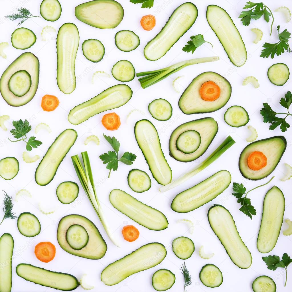 Food composition with avocadoes, cucumbers, carrots, celery, green onions, parsley and dill isolated on white background