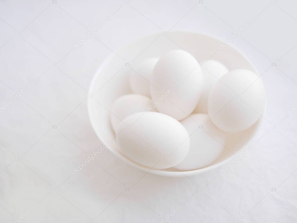 Close view of eggs in bowl on white background