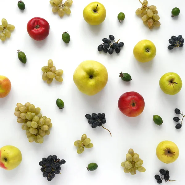 close-up photo of fresh fruits set of apples and grapes on white table background