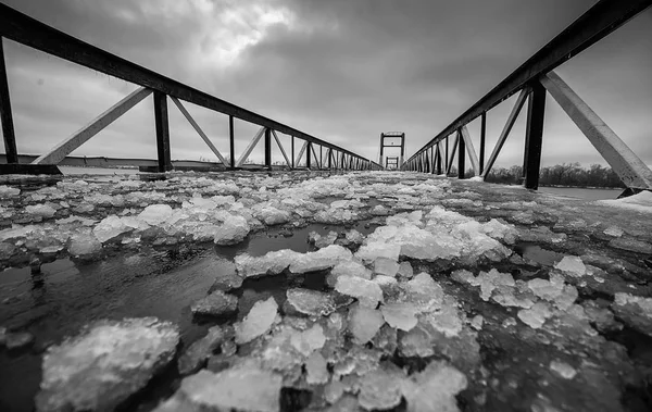 Bridge dotted with shards of broken ice in the winter