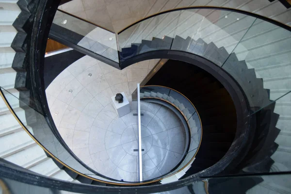 Image from above of a beautiful spiral staircase inside an urban structure