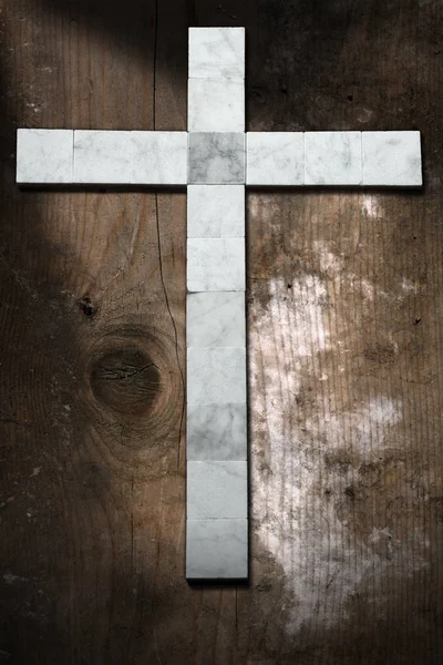 Marble Cross on an Old  Wooden Background — Stock Photo, Image