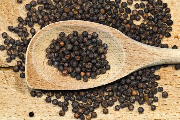 Peppercorns on a Wooden Spoon