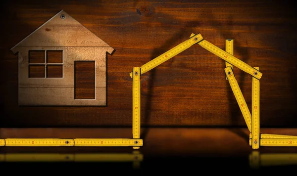 Dřevěný dům a vládce - stavební průmysl koncept — Stock fotografie