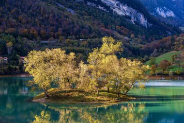 Lago di Tenno - Small lake with island in Italian Alps Trentino Italy clipart