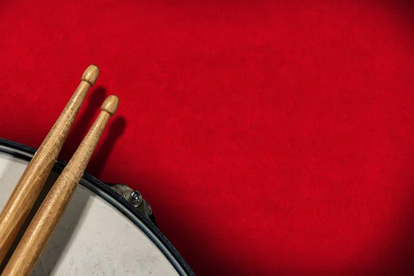 Drumsticks and snare drum on red velvet background - Percussion instrument — 스톡 사진