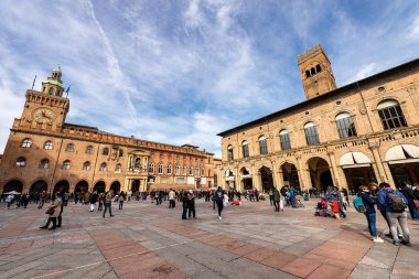 BOLOGNA, EMILIA-ROMAGNA, ITALY, - FEB 23, 2020: Piazza Maggiore with Podesta palace and Re Enzo palace with Arengo tower. Accursio palace with Accursi clock tower (Town hall in downtown of Bologna, XIII century). Emilia-Romagna, Italy, Europe