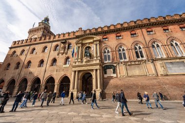 BOLOGNA, EMILIA-ROMAGNA, ITALY, - FEB 23, 2020: Piazza Maggiore with the Accursio palace and Accursi Tower, ancient palace used as a town hall in downtown of Bologna, XIII century. Emilia-Romagna, Italy, Europe