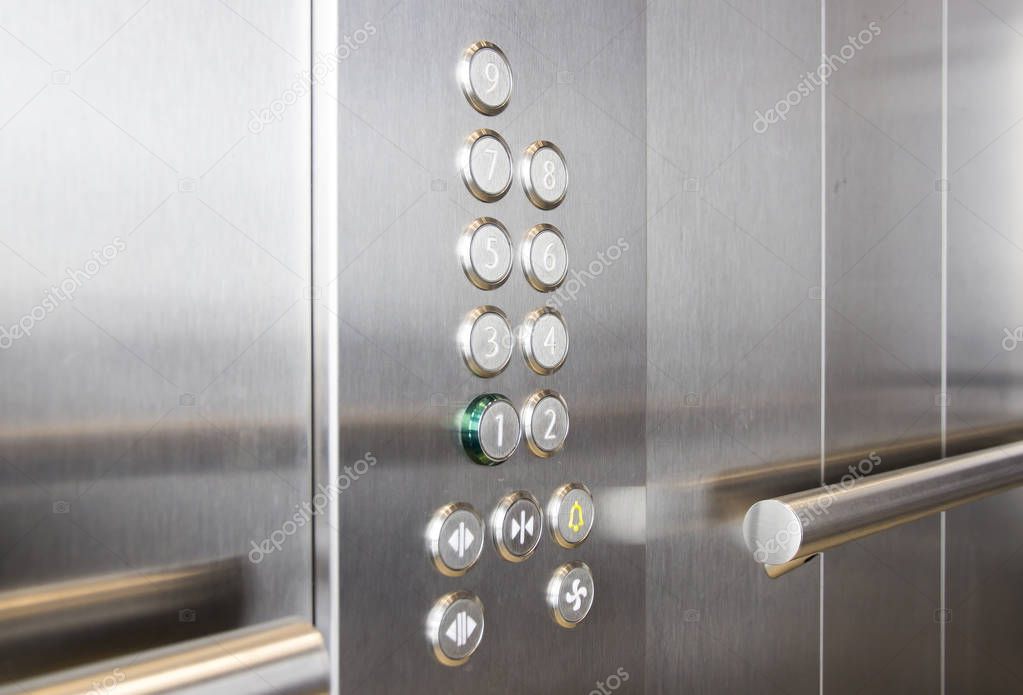 Buttons and handrail in modern elevator business centers