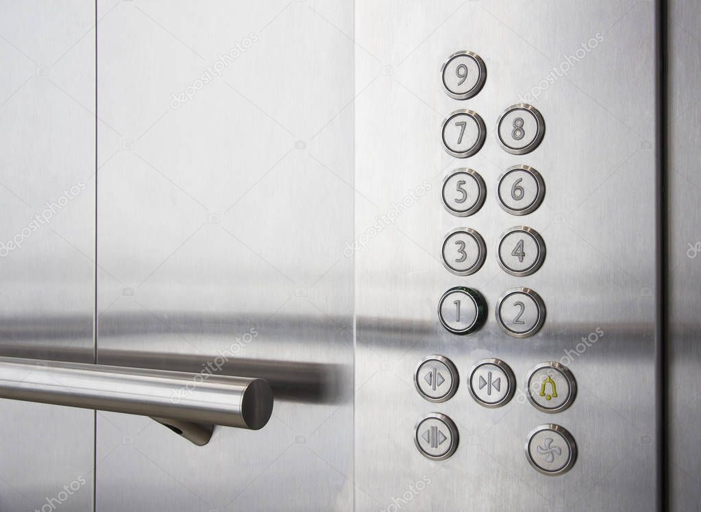 Buttons and handrail in modern elevator business centers