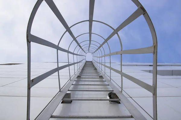 Outdoor fire escape at facade of building in perspective Stock Picture