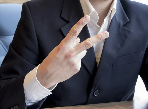 Man shows hand victory sign