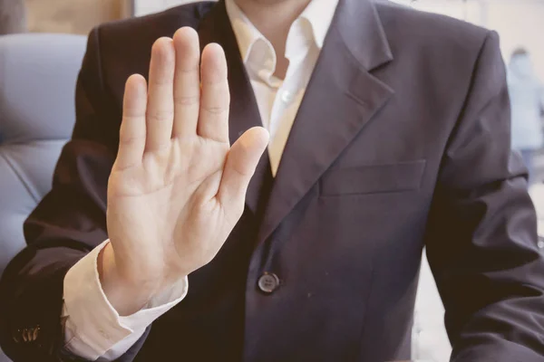 Men\'s hand showing stop sign