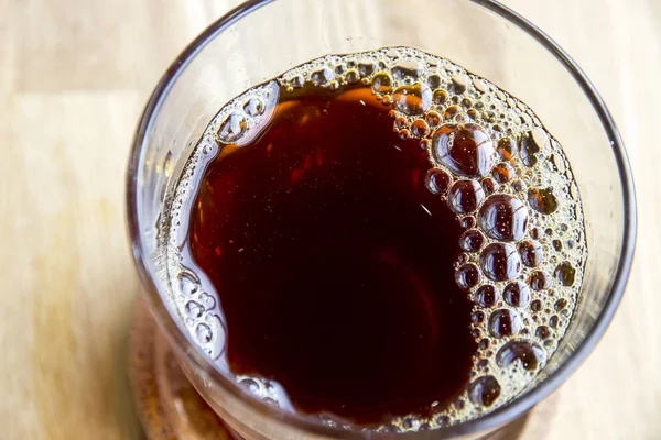 Freshly brewed coffee with bubbles in glass — Stock Photo, Image