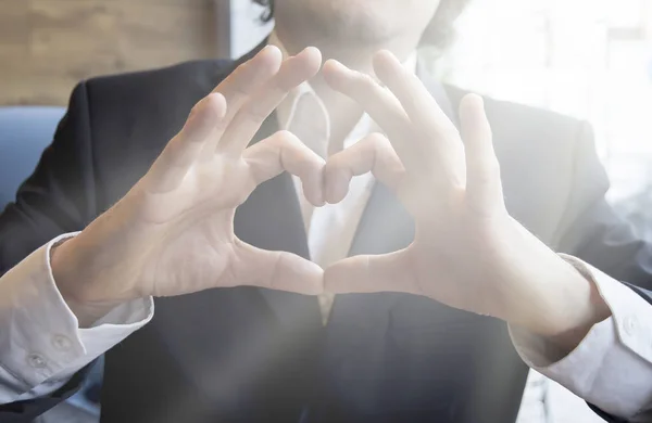 Man shows hand heart sign