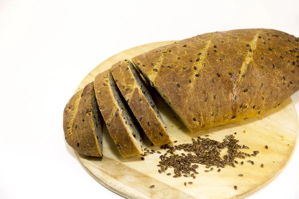 Bread handmeid with flax is cut into slices — Stock Photo, Image