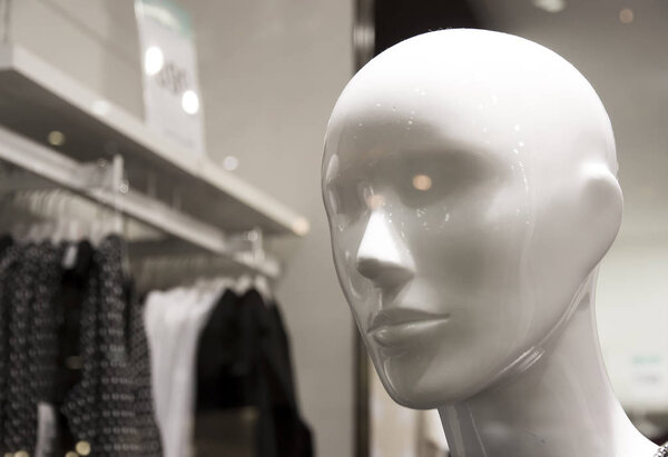 Head of male mannequin without hair in clothes 