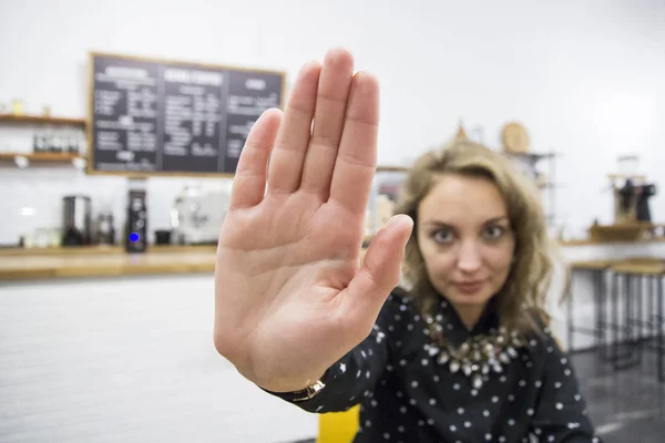 Young girl shows hand stop sign