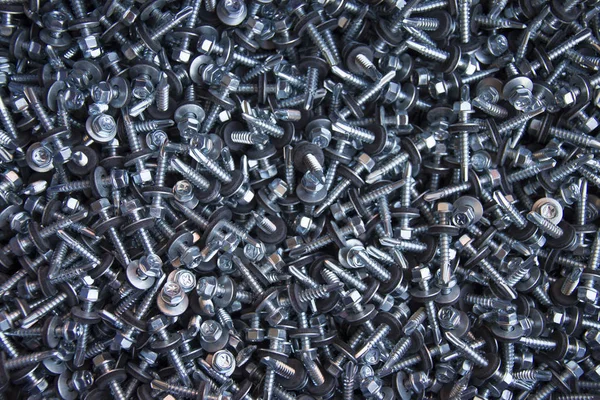 Large number of screws with washer on them — Stock Photo, Image